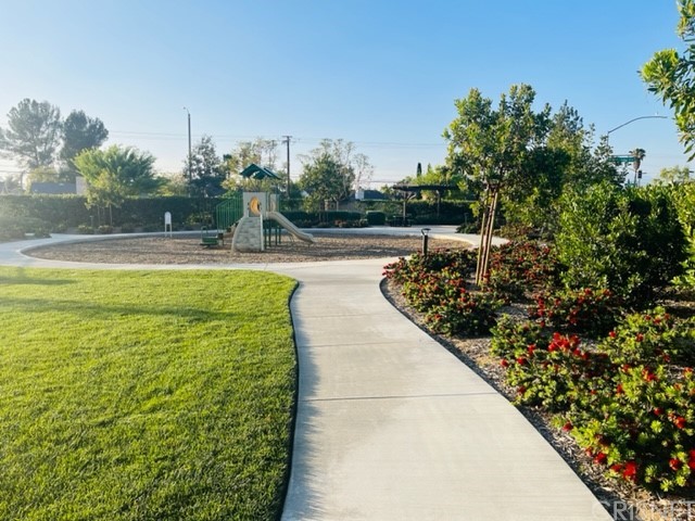 610 West Woodcrest Street Rialto, CA 92376 - Photo 32 of 33 a view of a swimming pool with a bench and trees around