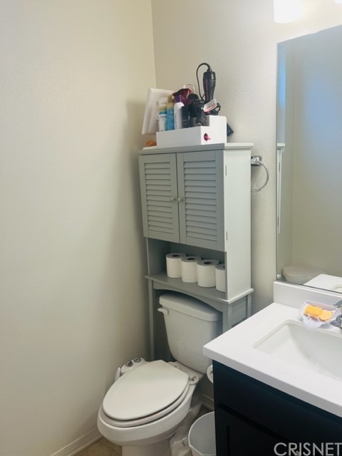 610 West Woodcrest Street Rialto, CA 92376 - Photo 9 of 33 a bathroom with a sink a toilet and vanity