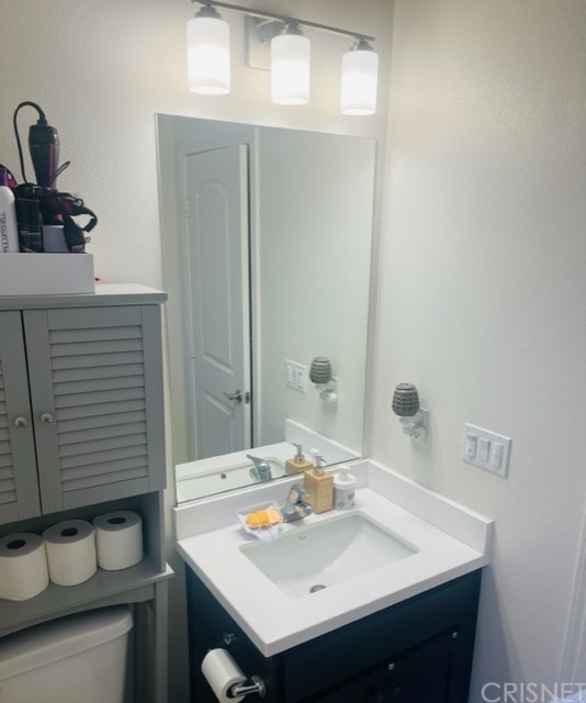 610 West Woodcrest Street Rialto, CA 92376 - Photo 10 of 33 a bathroom with a sink and a mirror