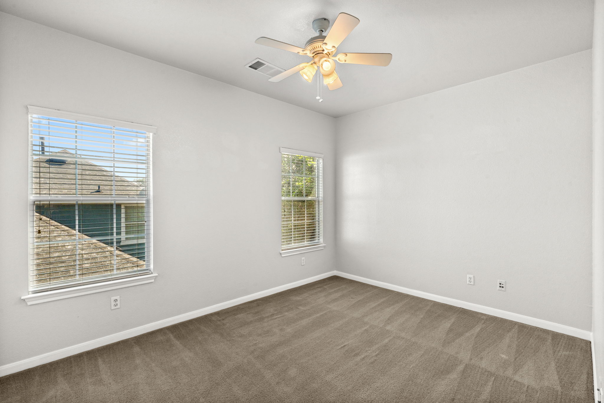 6704 Menchaca Road, Unit 42 Austin, TX 78745 - Photo 14 of 21 A quiet bedroom offers ample natural light and plush carpeting for comfortable living.