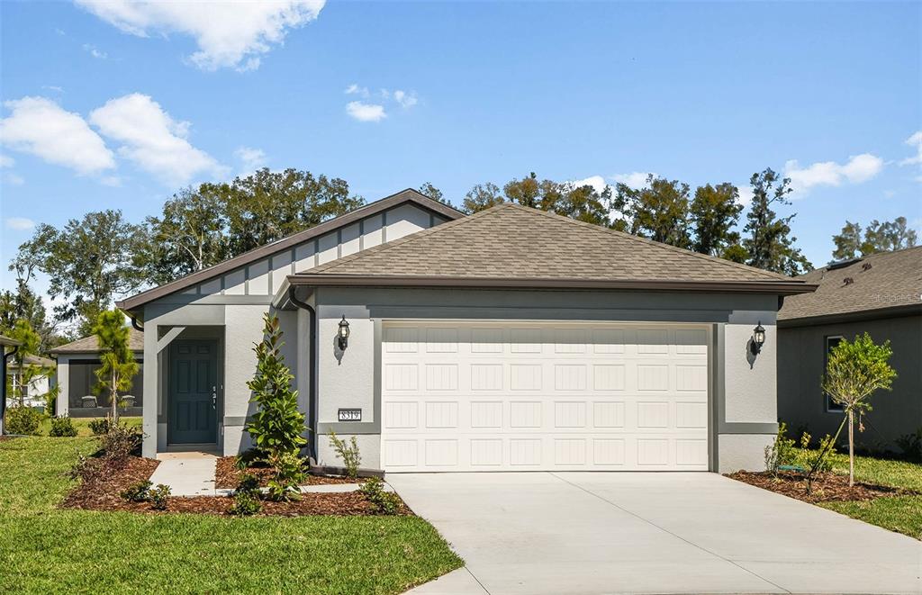 8319 Southwest 54th Loop Ocala, FL 34481 - Photo 1 of 1 a front view of a house with garden