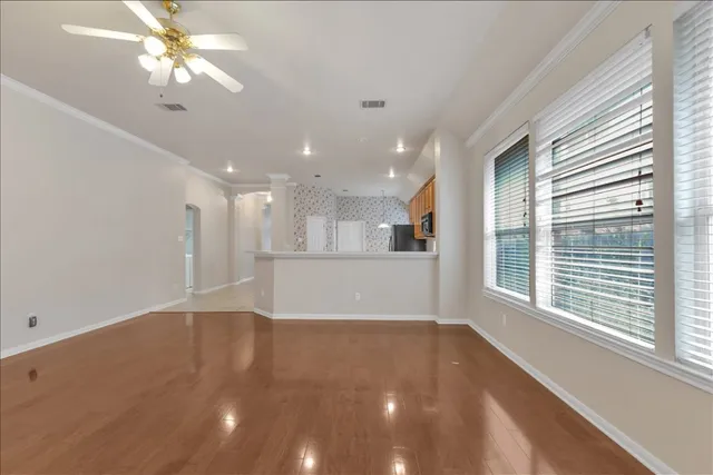 a view of a livingroom with a ceiling fan and window