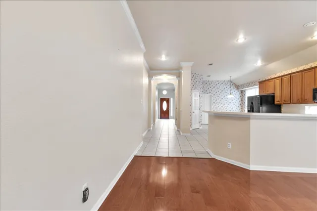 a view of a kitchen with wooden floor and a sink