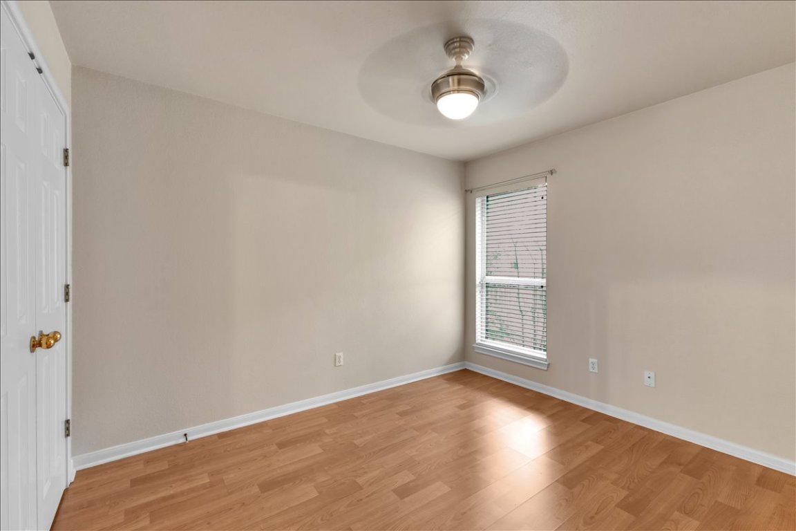 9237 La Siesta Bend Austin, TX 78749 - Photo 20 of 29 an empty room with wooden floor and windows