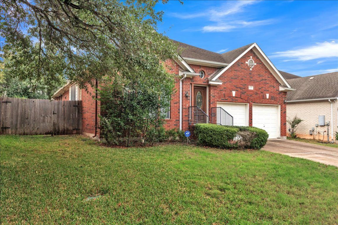 9237 La Siesta Bend Austin, TX 78749 - Photo 2 of 29 a front view of a house with a yard and garage