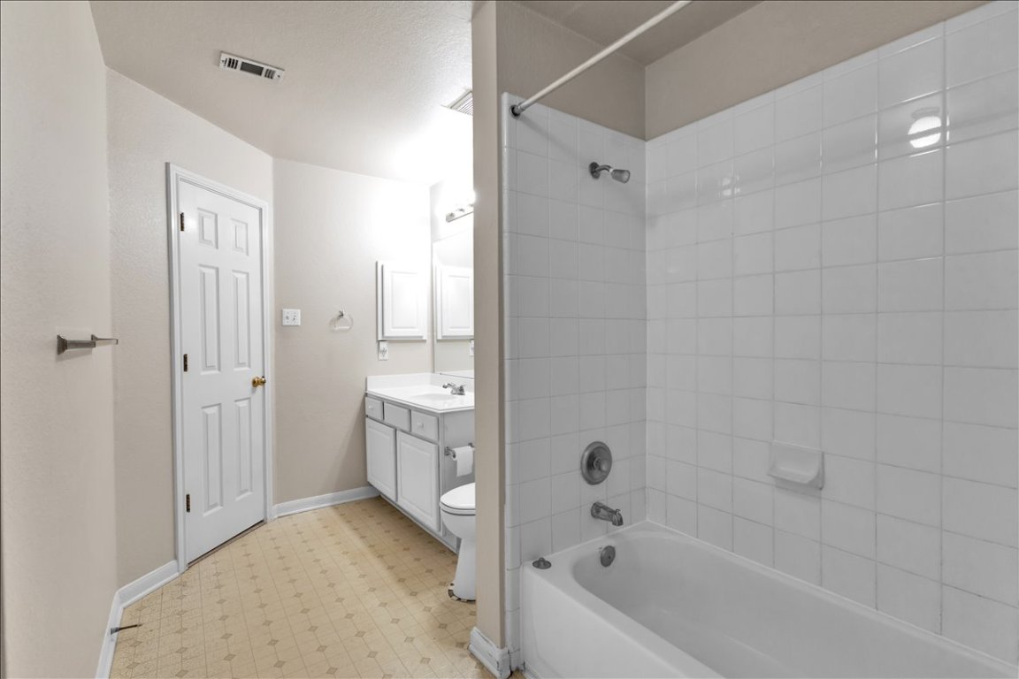9237 La Siesta Bend Austin, TX 78749 - Photo 21 of 29 a bathroom with a tub shower sink vanity and toilet