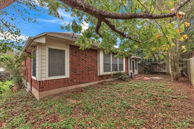 a view of a house with a yard and tree