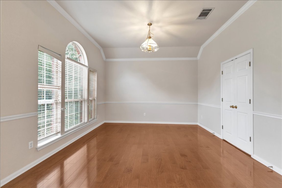 9237 La Siesta Bend Austin, TX 78749 - Photo 5 of 29 wooden floor in an empty room with a window