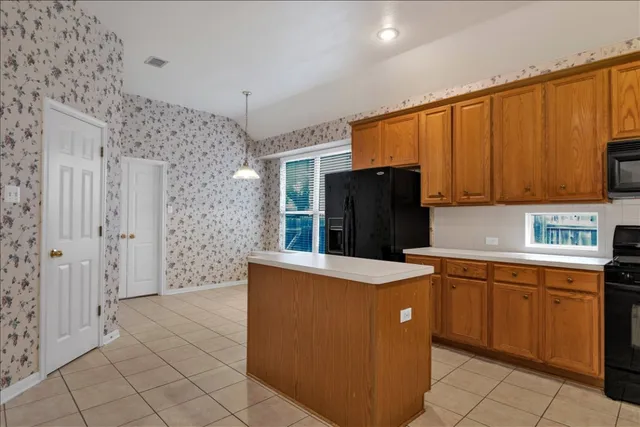 a kitchen with stainless steel appliances a refrigerator and a stove