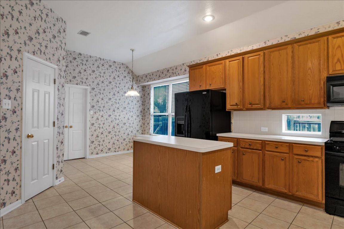 9237 La Siesta Bend Austin, TX 78749 - Photo 8 of 29 a kitchen with stainless steel appliances a refrigerator and a stove