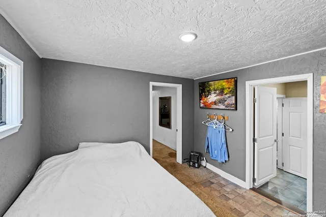 a bedroom with a bed and a window