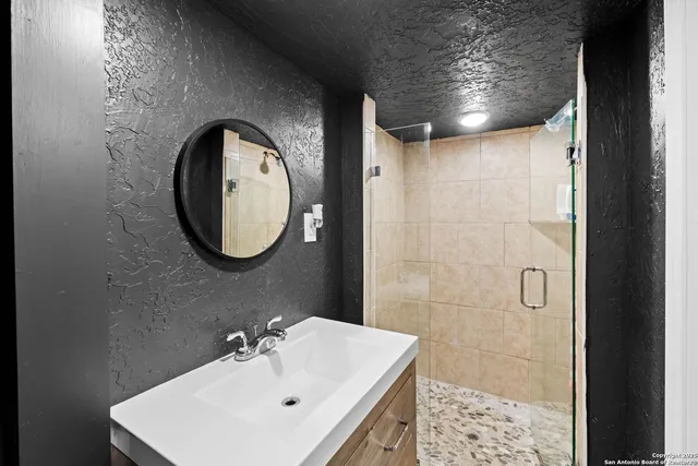 a bathroom with a sink and a mirror
