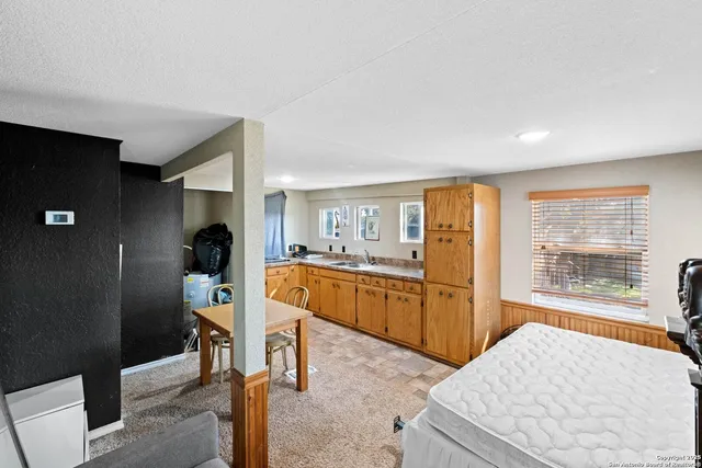 a large bedroom with a bed and furniture