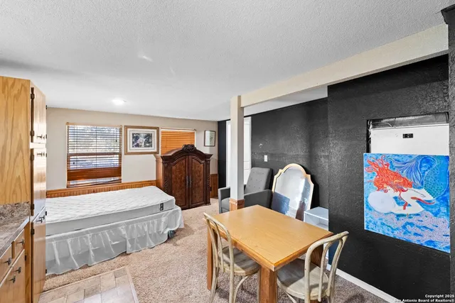 a bedroom with furniture and a window