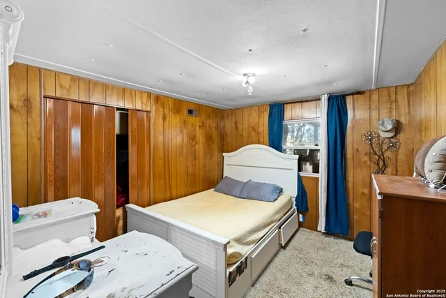 a bedroom with a bed and a dresser