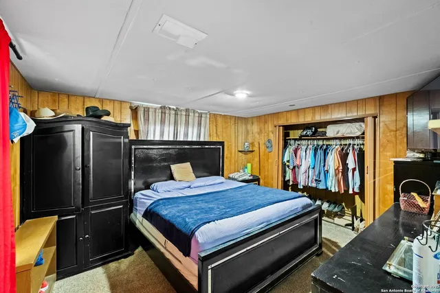 a bedroom with a bed dresser and a window