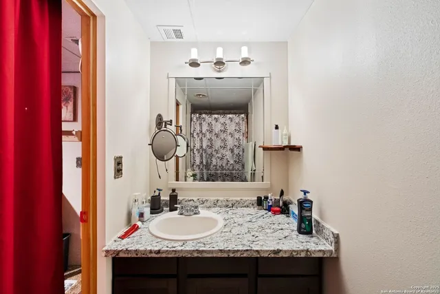 a bathroom with a sink and a mirror