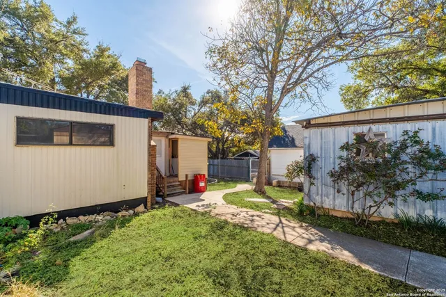 a view of a backyard with a tree