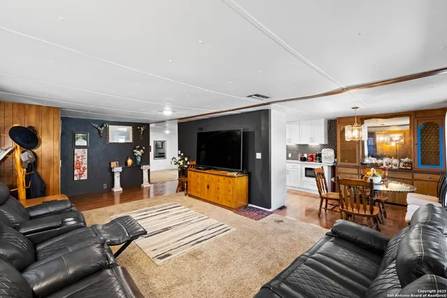 a bedroom with furniture and a flat screen tv
