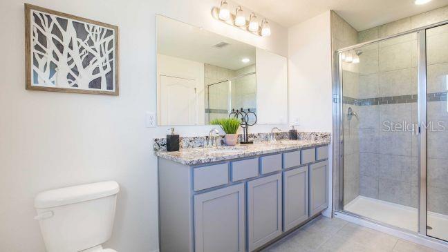 3592 Summitview Drive Lakeland, FL 33803 - Photo 11 of 23 a bathroom with a granite countertop sink a toilet and a shower