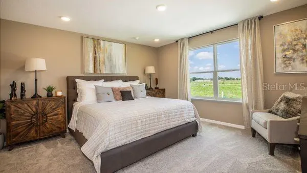 a bedroom with a bed and a lamp on table