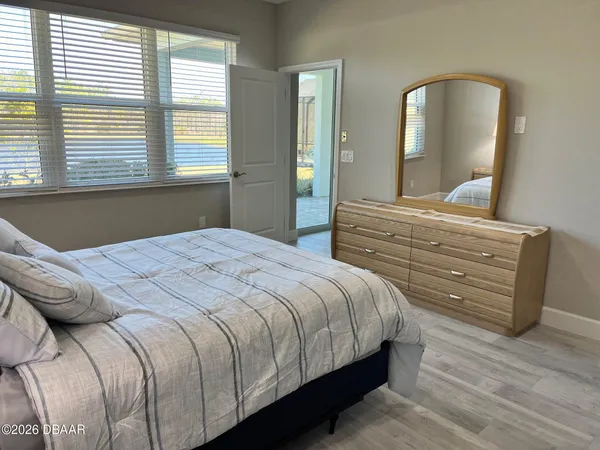 a bedroom with bed and lamp