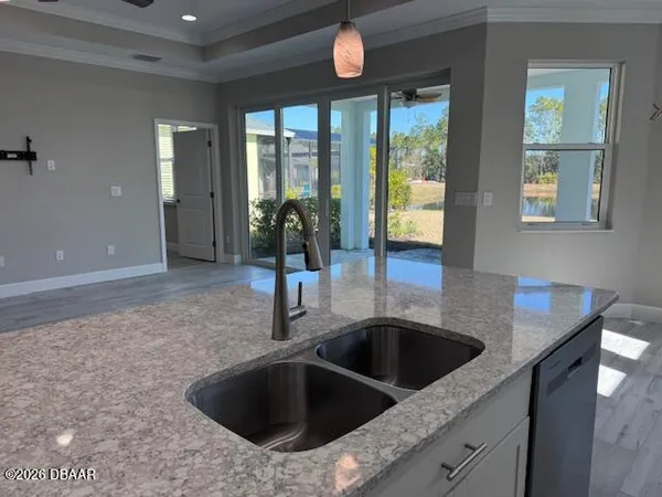 a kitchen with a sink and chandelier