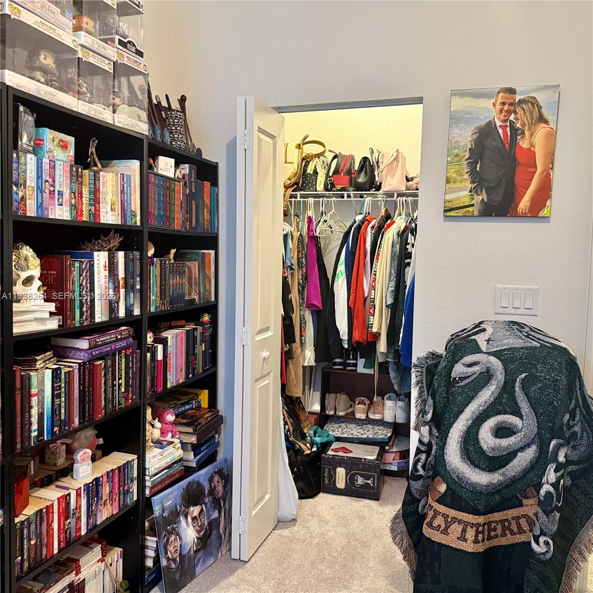 23049 Southwest 129th Place Miami, FL 33177 - Photo 20 of 33 a view of walk in closet with clothes and shoes