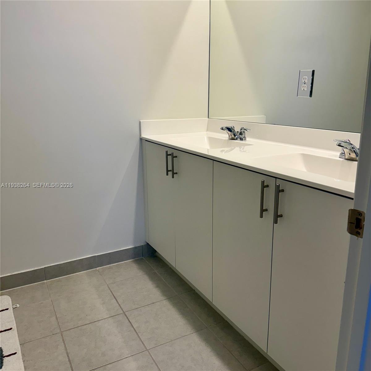 23049 Southwest 129th Place Miami, FL 33177 - Photo 28 of 33 a bathroom with a sink and a mirror