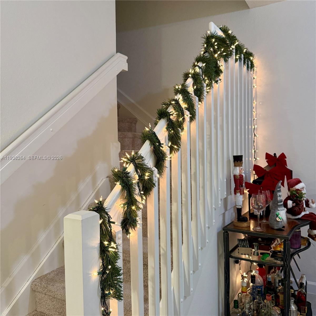 23049 Southwest 129th Place Miami, FL 33177 - Photo 5 of 33 a view of a hallway with wooden floor and a potted plant