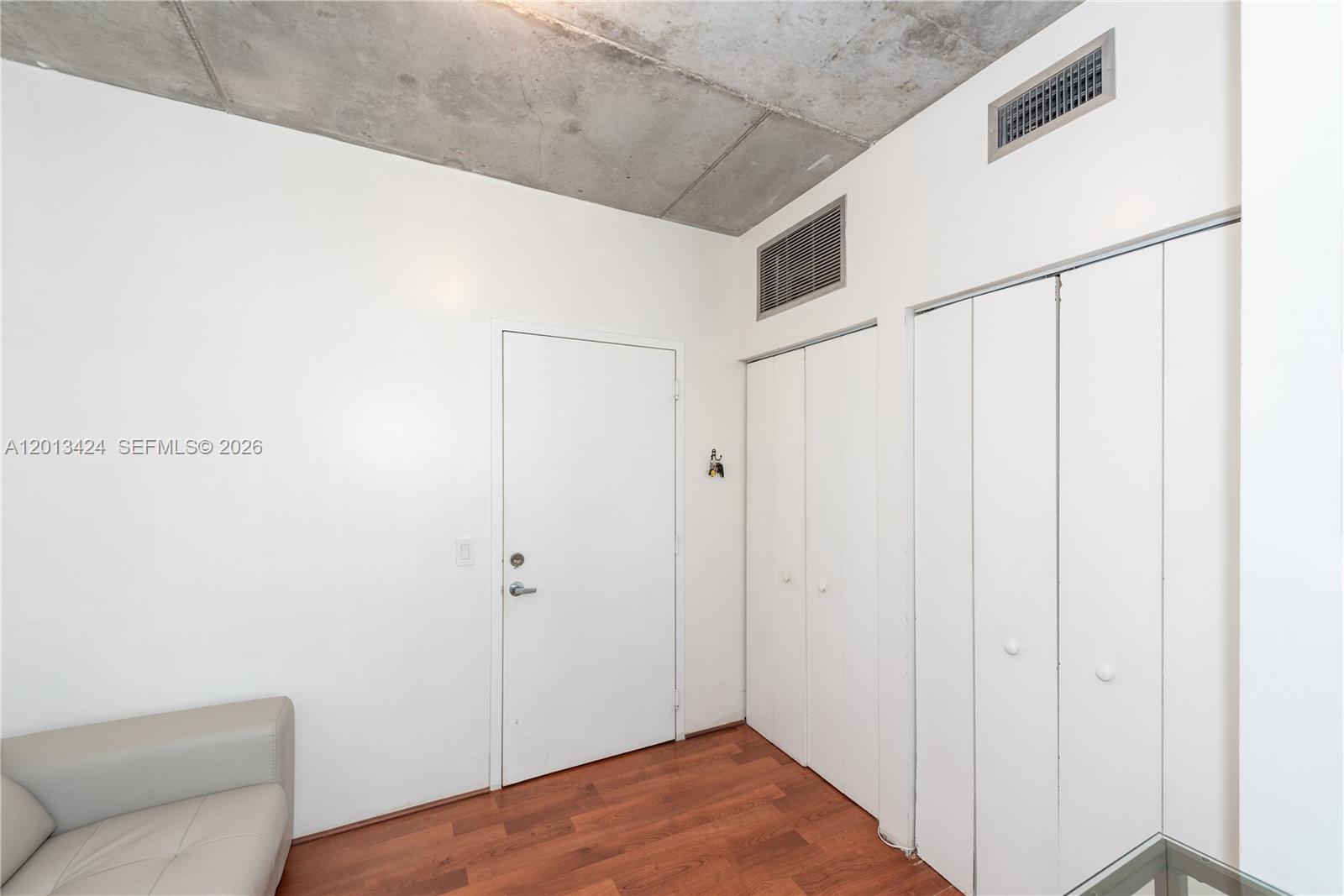 690 Southwest 1st Court, Unit 1034 Miami, FL 33130 - Photo 11 of 12 a view of a room with wooden floor and cabinet