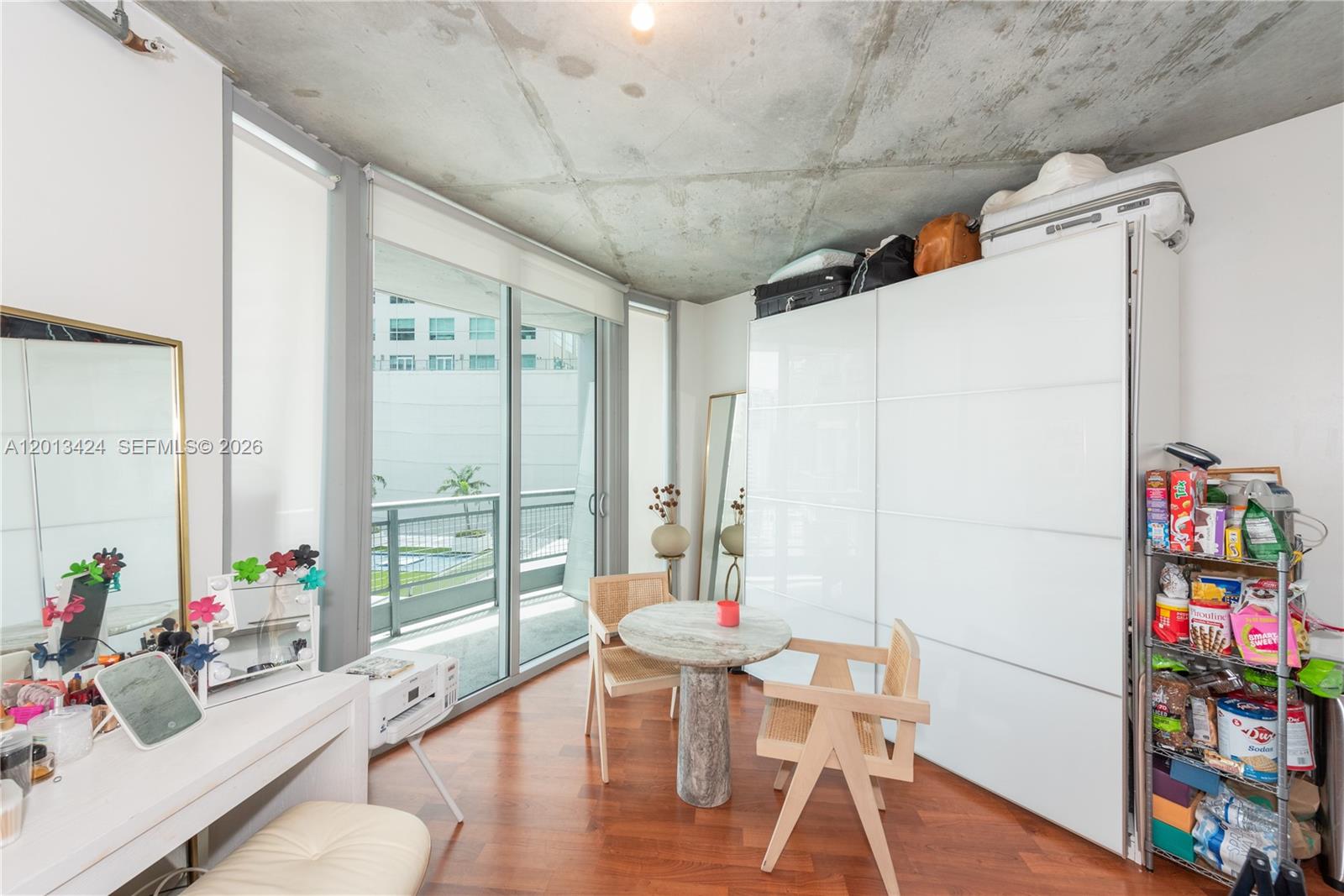 690 Southwest 1st Court, Unit 1034 Miami, FL 33130 - Photo 5 of 12 a view of a dining room with furniture window and wooden floor