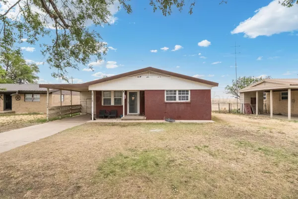 outdoor view of a house with a yard and garage
