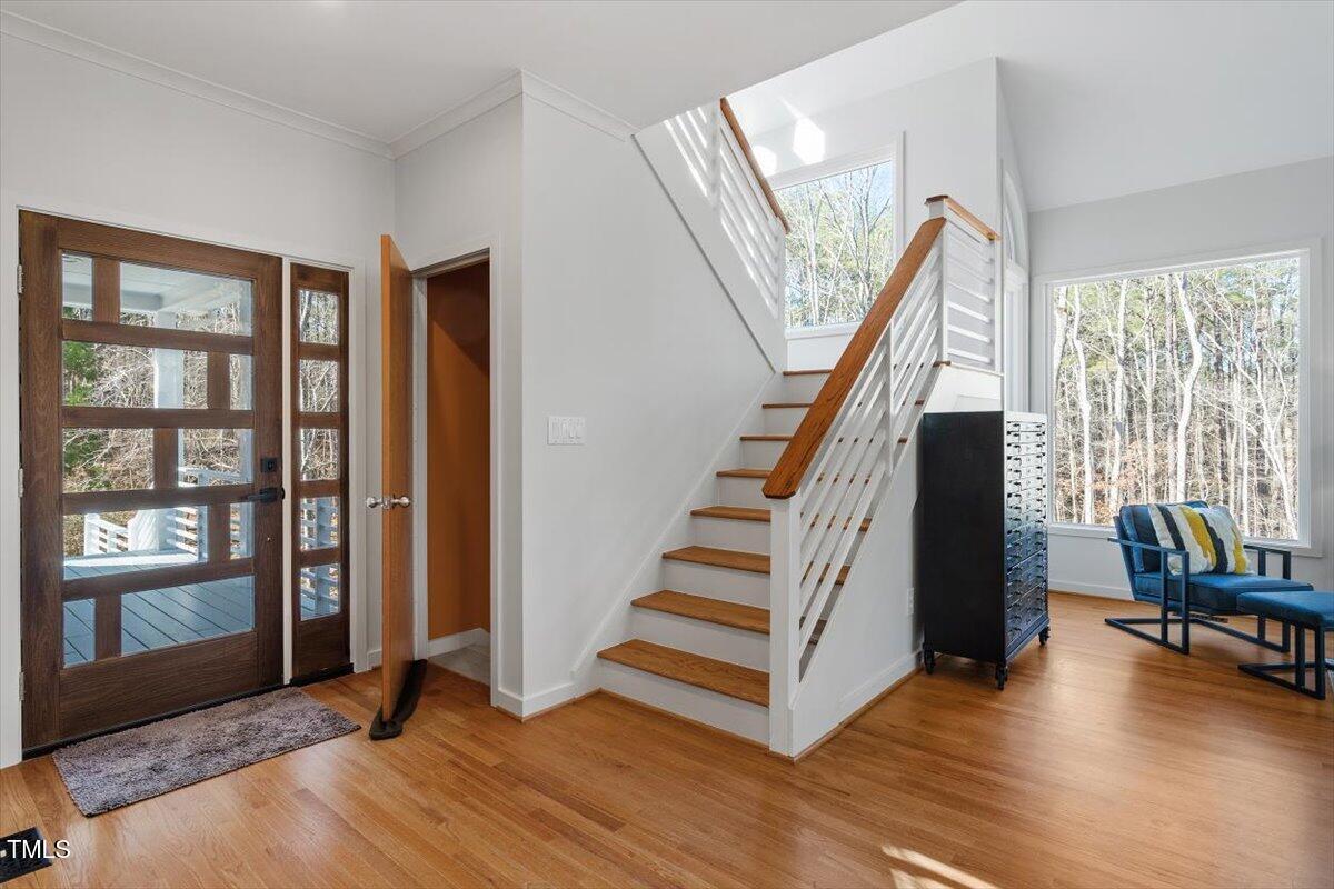 5920 Orchid Valley Road Raleigh, NC 27613 - Photo 19 of 54 Foyer facing stairs down to basement entry and stairs to second floor