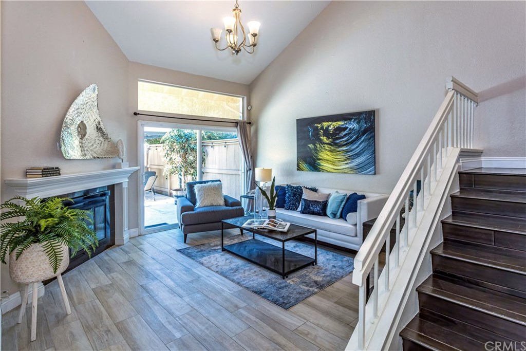 a living room with furniture a fireplace and a large window