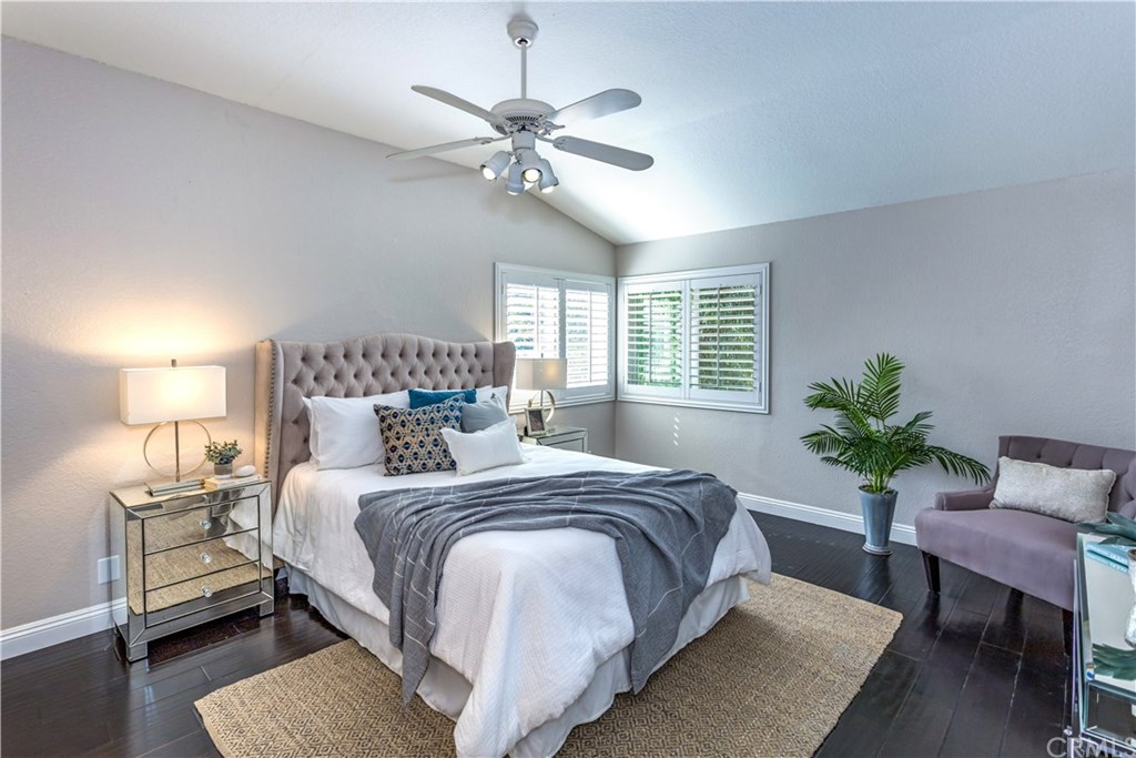 11 Silveroak Aliso Viejo, CA 92656 - Photo 16 of 41 a bedroom with a large bed and a chandelier