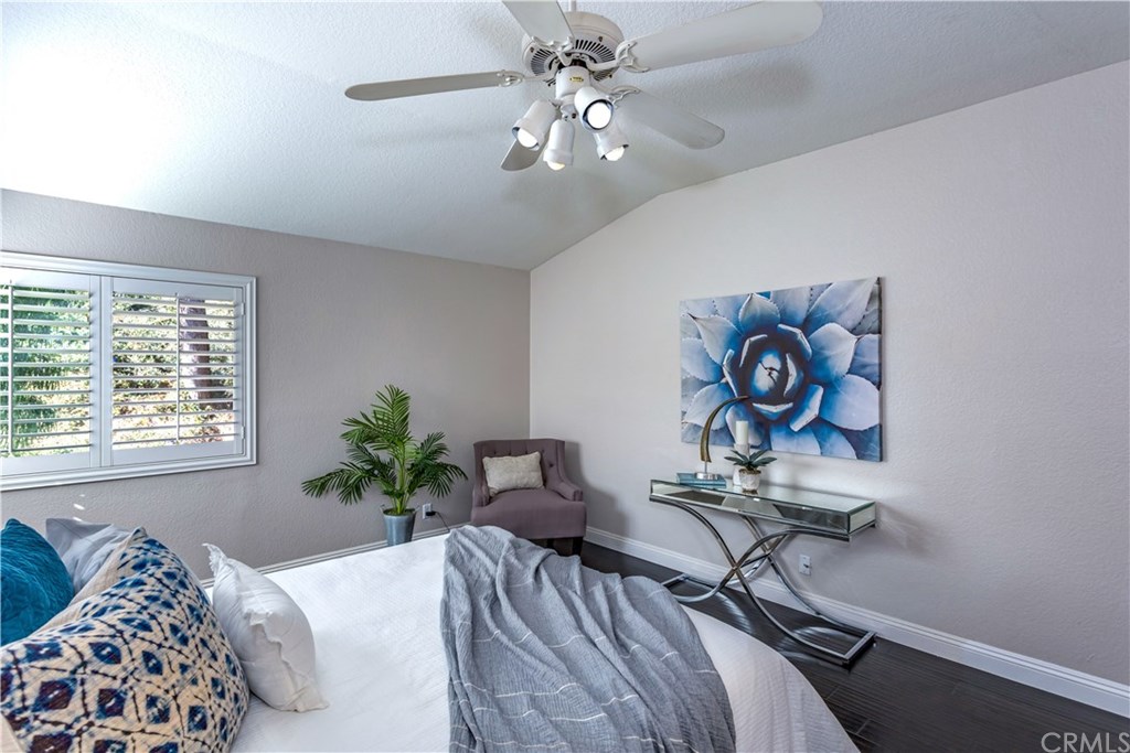 11 Silveroak Aliso Viejo, CA 92656 - Photo 19 of 41 a bedroom with a bed and a chandelier