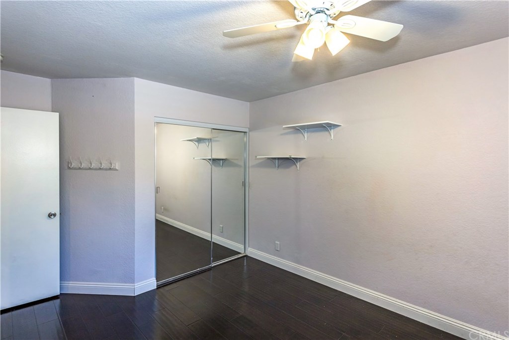 11 Silveroak Aliso Viejo, CA 92656 - Photo 23 of 41 a view of an empty room with wooden floor and a ceiling fan