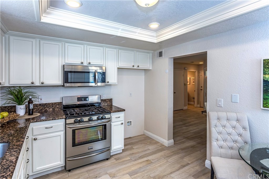 11 Silveroak Aliso Viejo, CA 92656 - Photo 8 of 41 a kitchen with cabinets stainless steel appliances and wooden floor
