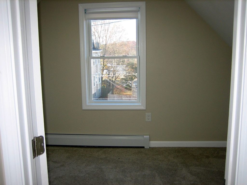 9 Pearl Street, Unit 2 Ayer, MA 01432 - Photo 6 of 10 a view of an empty room with a window