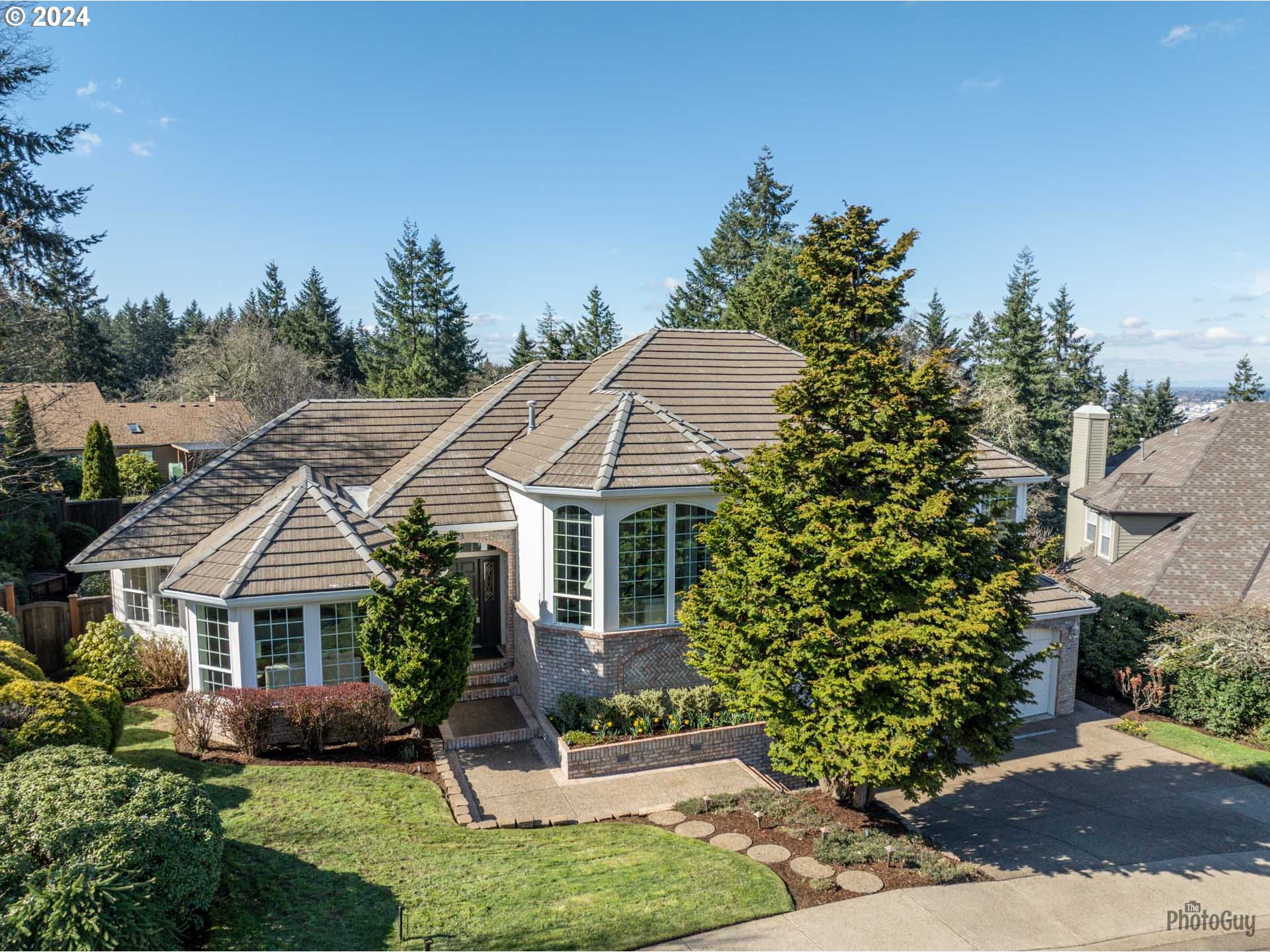 2054 Morning View Drive Eugene, OR 97405 - Photo 3 of 48 a front view of a house with a garden and trees