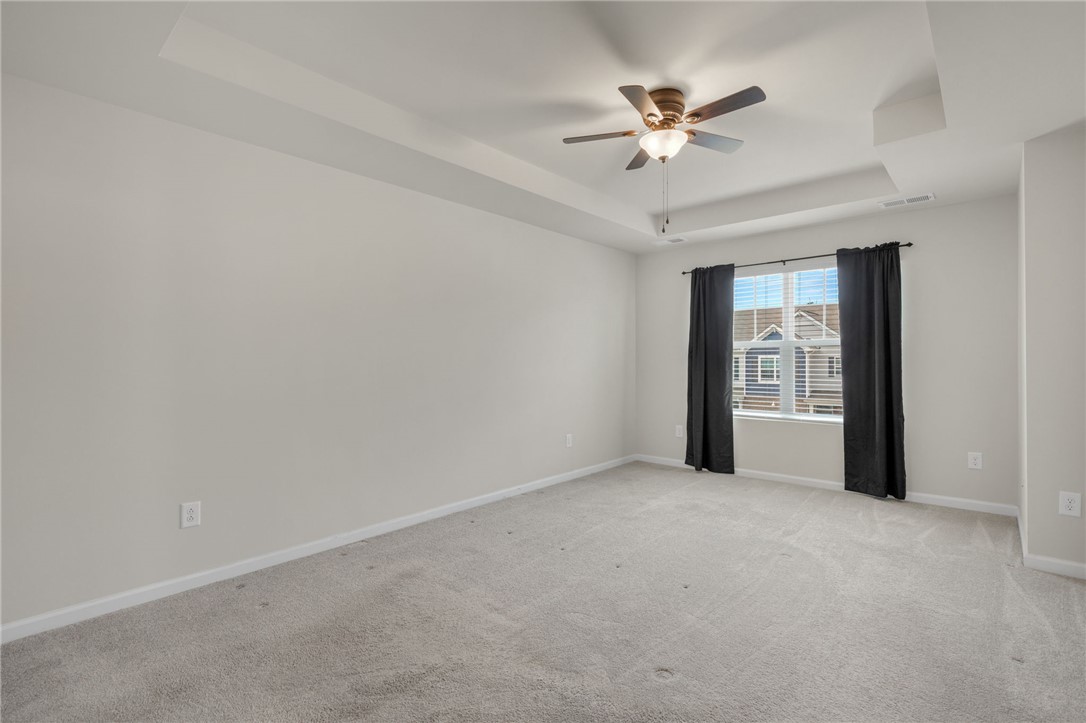 432 Bee Cv Way Pendleton, SC 29670 - Photo 18 of 39 This spacious primary bedroom features soft carpeting and a beautiful tray ceiling.