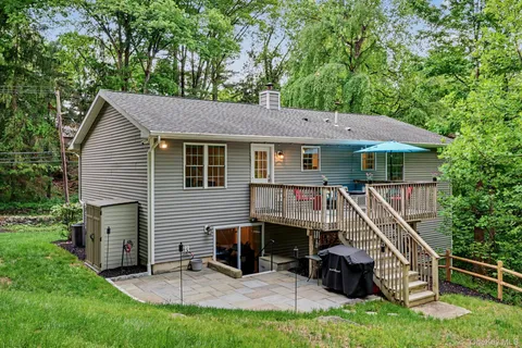 a view of a house with a chairs in a patio