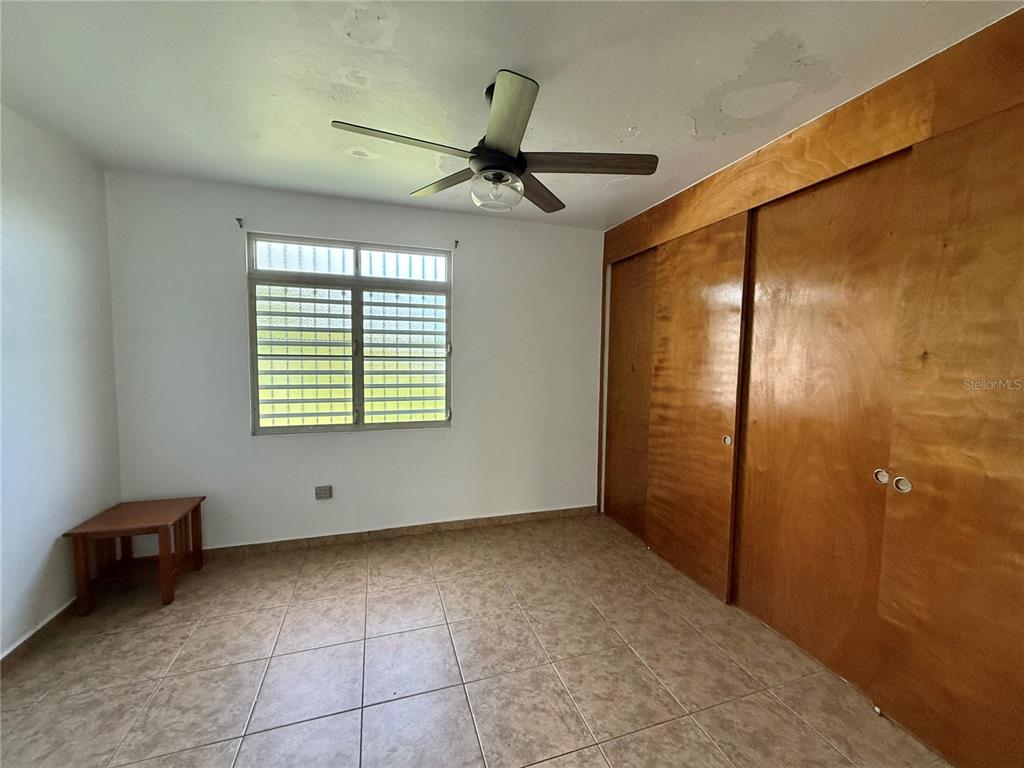 411 Bo Calvache Rincon, PR 00677 - Photo 4 of 14 an empty room with windows and fan