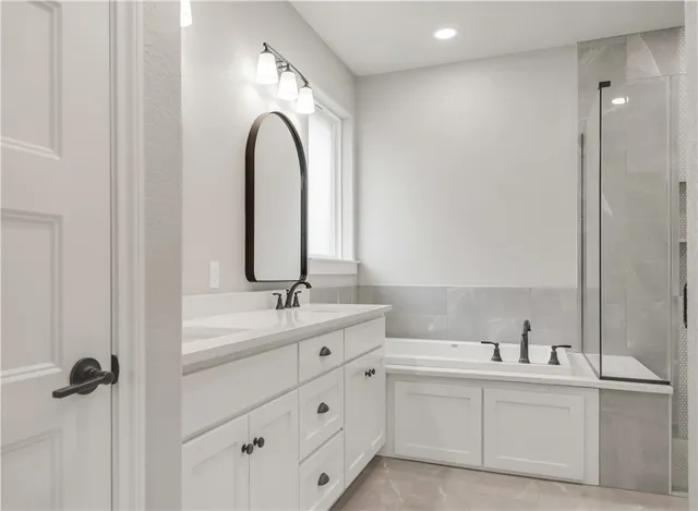 a bathroom with a double vanity sink mirror and