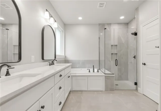 a bathroom with a double vanity sink mirror double and bathtub