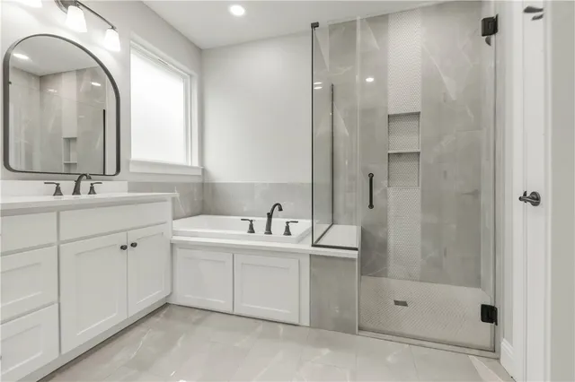 a bathroom with a double vanity sink mirror and shower