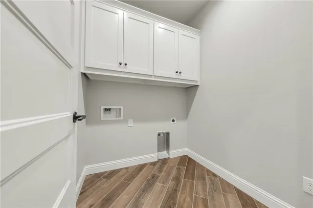 a view of storage and utility room with wooden floor