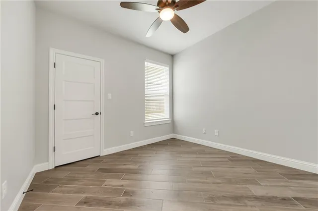wooden floor in an empty room with a window
