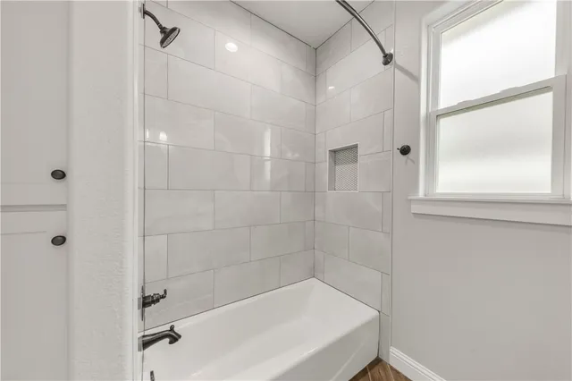 a bathroom with a bathtub and a shower